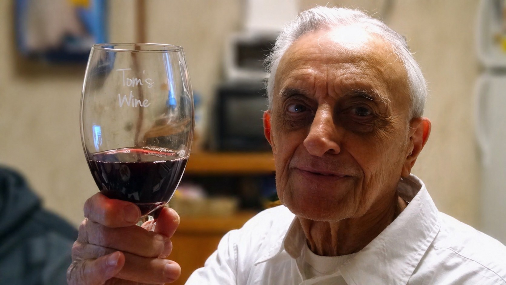 Thomas Oriolo, Vincent's grandfather and the namesake of CrossGuard, raising a wine glass etched 'Tom's Wine'.